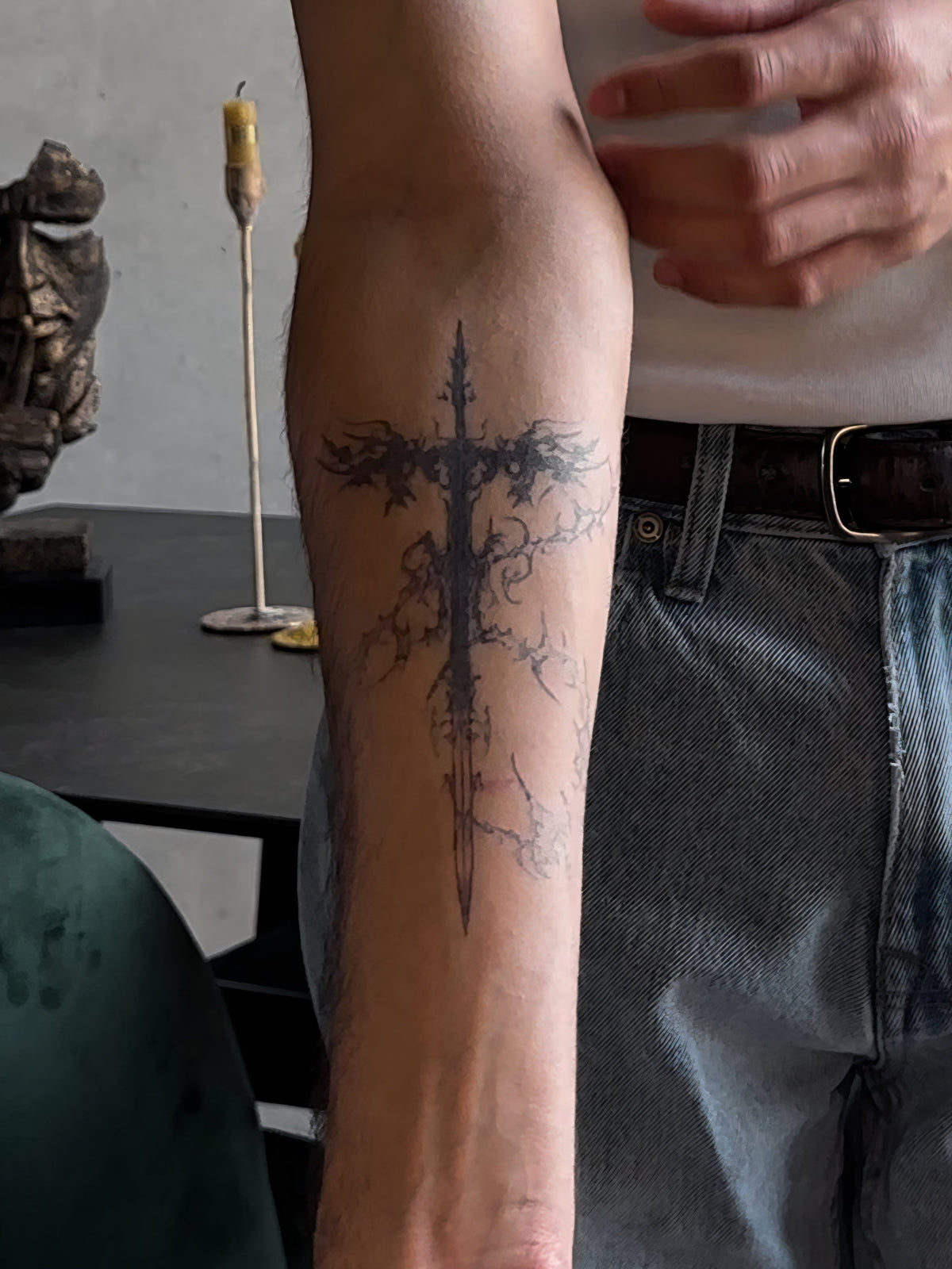 Fine line dagger tattoo on a forearm worn as a test before a real tattoo