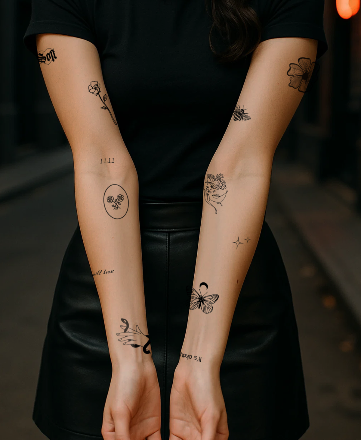 Arms with several small temporary tattoos in different styles